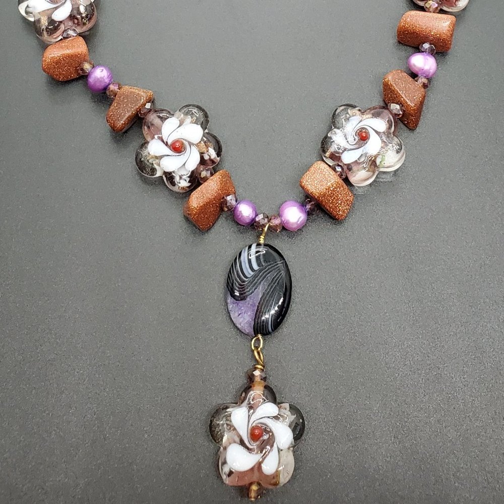 One-of-a-kind, hand-made-glass with goldstone pearls.